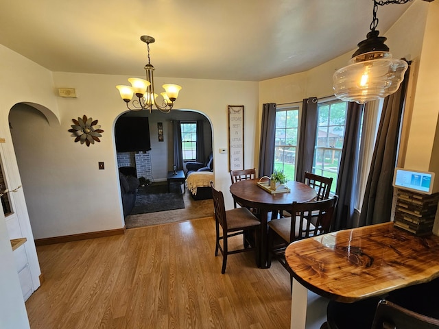 205 2nd Ave W, Lamberton, MN 56152 - dining room with arched walkways, wood finished floors, plenty of natural light, and a chandelier