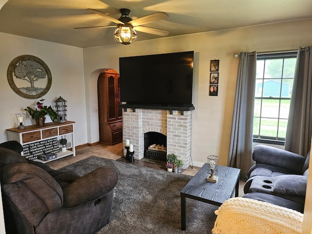205 2nd Ave W, Lamberton, MN 56152 - living room with ceiling fan, arched walkways, carpet, baseboards, and a brick fireplace