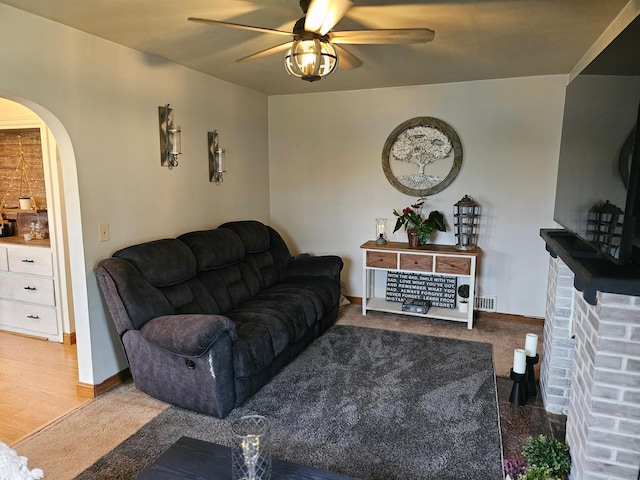 205 2nd Ave W, Lamberton, MN 56152 - living room featuring arched walkways, ceiling fan, and baseboards