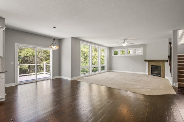 1206 Rosemary Ln, Chaska, MN 55318 - unfurnished living room featuring baseboards, ceiling fan, and a fireplace