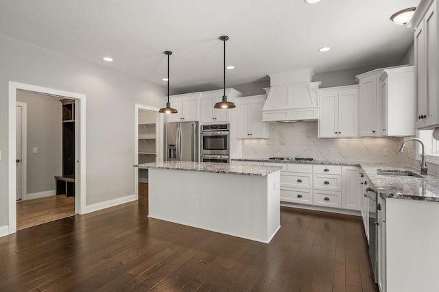 1206 Rosemary Ln, Chaska, MN 55318 - kitchen featuring stainless steel appliances, a sink, custom range hood, backsplash, and light stone counters