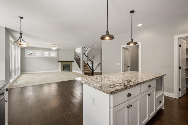 1206 Rosemary Ln, Chaska, MN 55318 - kitchen featuring ceiling fan, open floor plan, dark wood-style flooring, white cabinets, and light stone counters