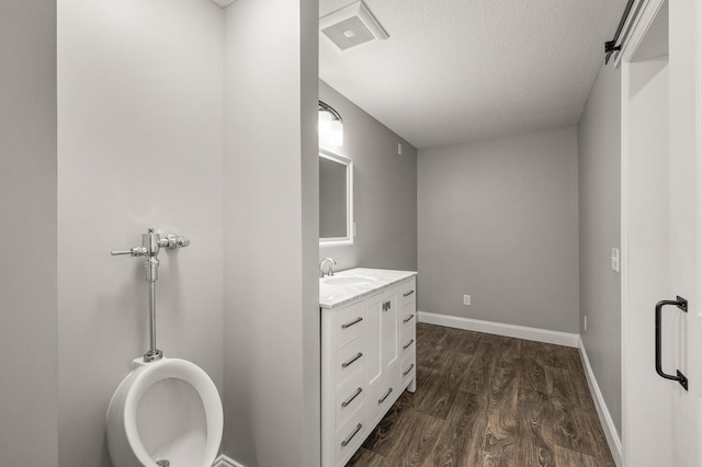 1206 Rosemary Ln, Chaska, MN 55318 - bathroom with vanity, wood finished floors, a textured ceiling, baseboards, and toilet
