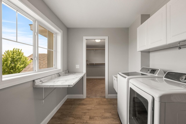 1206 Rosemary Ln, Chaska, MN 55318 - laundry room with cabinet space, wood finished floors, baseboards, and washer and clothes dryer