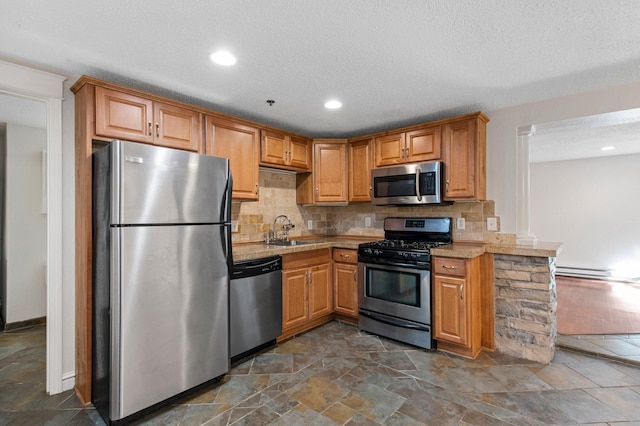 1930 Aldrich Ave S Unit C001, Minneapolis, MN 55403 - kitchen featuring appliances with stainless steel finishes, a sink, dark stone finish flooring, tasteful backsplash, and a textured ceiling