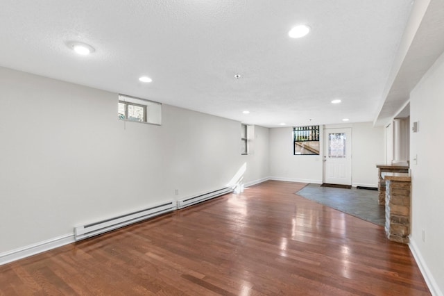 1930 Aldrich Ave S Unit C001, Minneapolis, MN 55403 - below grade area with a baseboard radiator, wood finished floors, recessed lighting, and baseboards