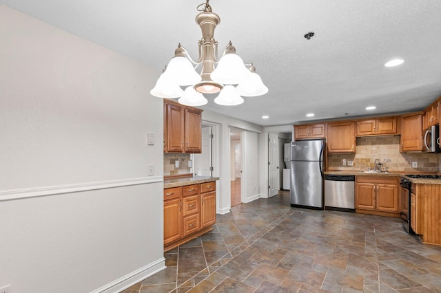 1930 Aldrich Ave S Unit C001, Minneapolis, MN 55403 - kitchen with stainless steel appliances, a chandelier, a sink, baseboards, and recessed lighting