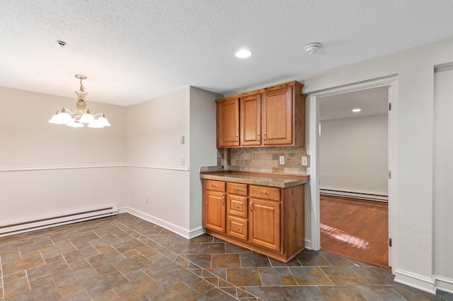 1930 Aldrich Ave S Unit C001, Minneapolis, MN 55403 - kitchen featuring a baseboard heating unit, brown cabinetry, baseboards, tasteful backsplash, and a textured ceiling