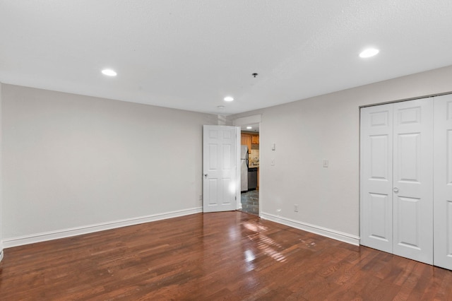 1930 Aldrich Ave S Unit C001, Minneapolis, MN 55403 - unfurnished bedroom with freestanding refrigerator, wood finished floors, baseboards, recessed lighting, and a closet