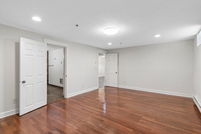 1930 Aldrich Ave S Unit C001, Minneapolis, MN 55403 - unfurnished bedroom featuring wood finished floors, baseboards, recessed lighting, and a baseboard radiator