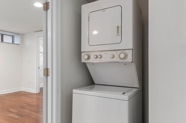 1930 Aldrich Ave S Unit C001, Minneapolis, MN 55403 - laundry room with stacked washer / dryer, wood finished floors, and baseboards