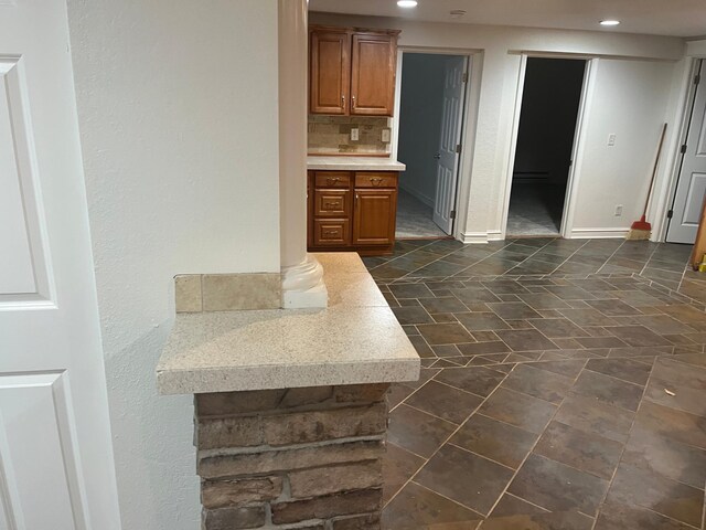 1930 Aldrich Ave S Unit C001, Minneapolis, MN 55403 - kitchen with light countertops, recessed lighting, brown cabinetry, decorative backsplash, and baseboards