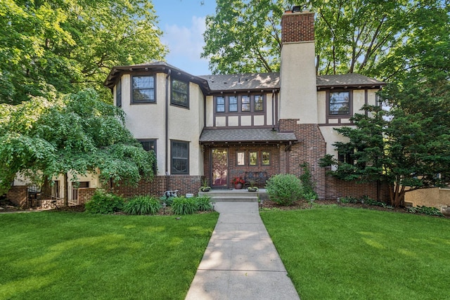 5319 Upton Ave S, Minneapolis, MN 55410 - tudor house featuring stucco siding, a chimney, and a front yard