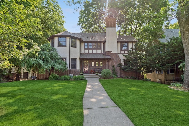 5319 Upton Ave S, Minneapolis, MN 55410 - english style home with a chimney, a front lawn, stucco siding, brick siding, and roof with shingles