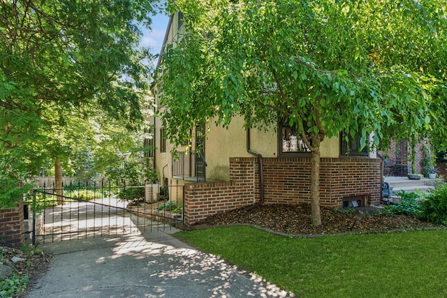 5319 Upton Ave S, Minneapolis, MN 55410 - view of side of property with stucco siding, a gate, driveway, and brick siding