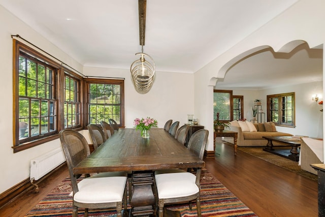 5319 Upton Ave S, Minneapolis, MN 55410 - dining area featuring radiator, arched walkways, healthy amount of natural light, and wood finished floors