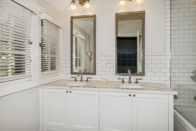 5319 Upton Ave S, Minneapolis, MN 55410 - bathroom with double vanity, shower / bath combination, tile walls, and decorative backsplash