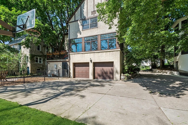 5319 Upton Ave S, Minneapolis, MN 55410 - view of front of house with stucco siding, concrete driveway, and a garage