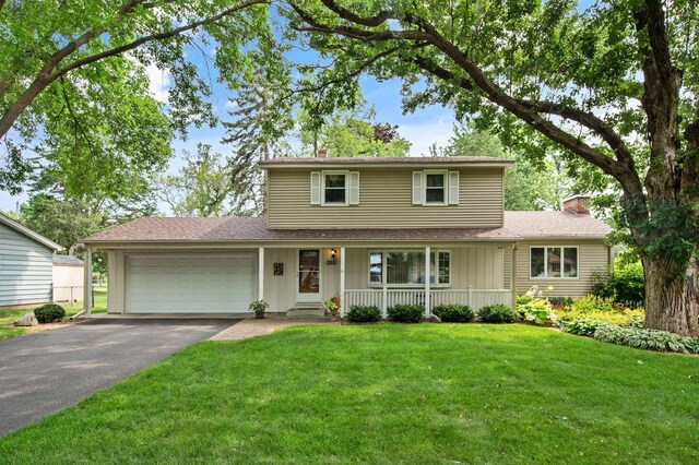 2168 Southwood Dr, White Bear Lake, MN 55110 - traditional-style house with a chimney, a garage, covered porch, board and batten siding, and driveway
