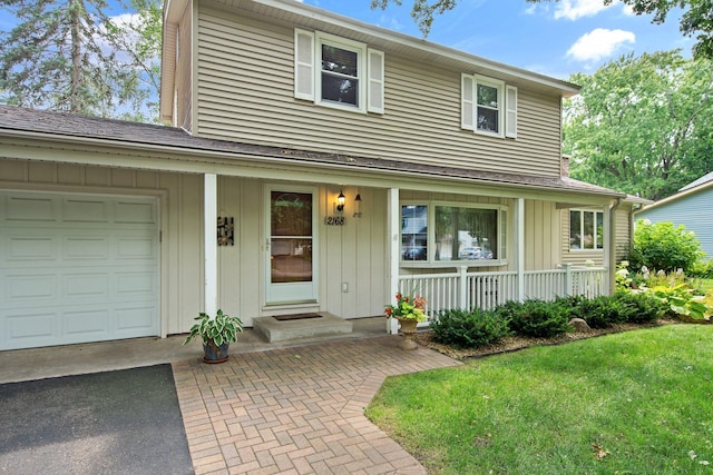 2168 Southwood Dr, White Bear Lake, MN 55110 - traditional-style house with an attached garage, a porch, board and batten siding, and asphalt driveway