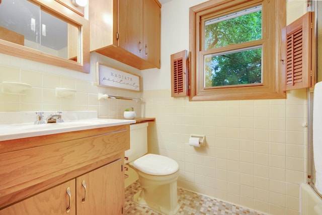 2168 Southwood Dr, White Bear Lake, MN 55110 - bathroom with tile walls, vanity, and tile patterned floors