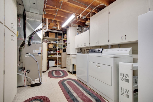 2168 Southwood Dr, White Bear Lake, MN 55110 - laundry room with cabinet space, washing machine and dryer, light floors, and heating unit