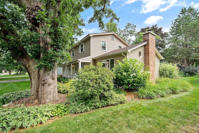 2168 Southwood Dr, White Bear Lake, MN 55110 - view of side of home featuring a chimney and a yard