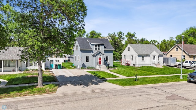 114 2nd Ave E, West Fargo, ND 58078 - view of front of home with concrete driveway, entry steps, a front yard, and a residential view
