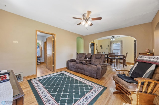114 2nd Ave E, West Fargo, ND 58078 - living room featuring arched walkways, a ceiling fan, wood finished floors, and baseboards