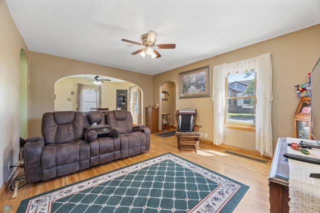 114 2nd Ave E, West Fargo, ND 58078 - living room featuring arched walkways, a ceiling fan, healthy amount of natural light, and wood finished floors