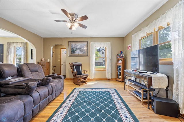114 2nd Ave E, West Fargo, ND 58078 - living room featuring arched walkways, healthy amount of natural light, wood finished floors, and ceiling fan
