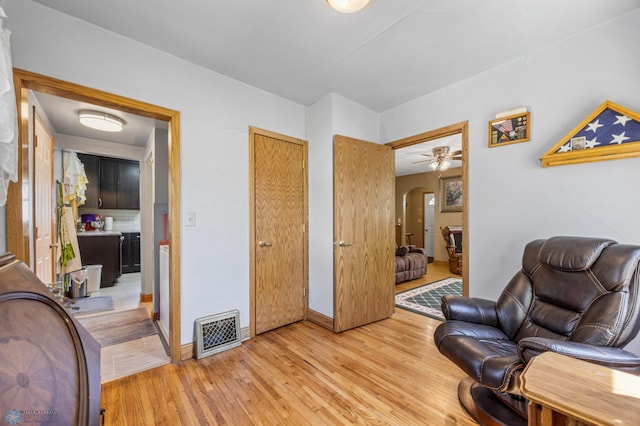 114 2nd Ave E, West Fargo, ND 58078 - living area featuring arched walkways, light wood-style floors, and baseboards