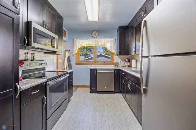114 2nd Ave E, West Fargo, ND 58078 - kitchen with appliances with stainless steel finishes, backsplash, light countertops, and baseboards