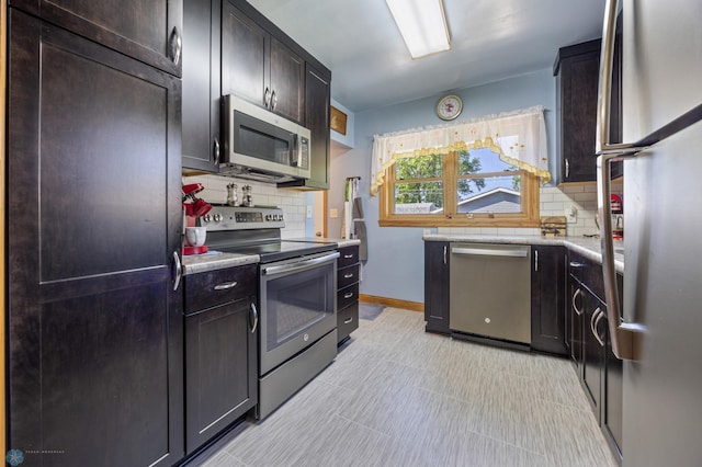 114 2nd Ave E, West Fargo, ND 58078 - kitchen with stainless steel appliances, tasteful backsplash, light countertops, and baseboards