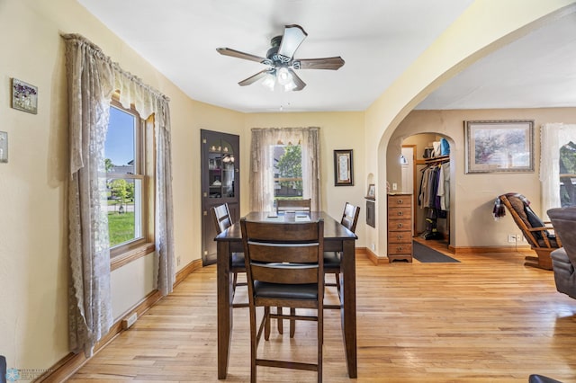 114 2nd Ave E, West Fargo, ND 58078 - dining area featuring arched walkways, healthy amount of natural light, a ceiling fan, and light wood-style flooring