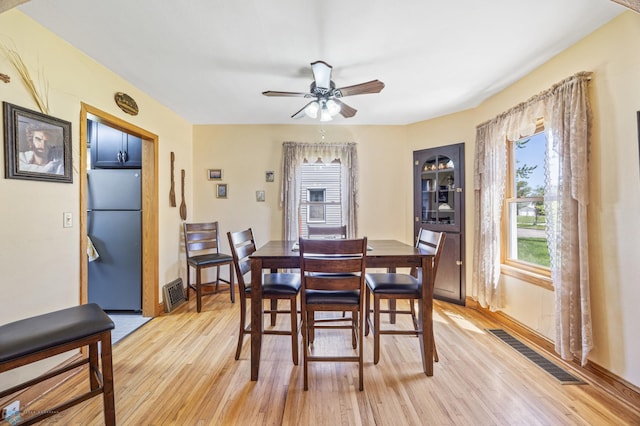 114 2nd Ave E, West Fargo, ND 58078 - dining room featuring light wood finished floors, healthy amount of natural light, ceiling fan, and baseboards