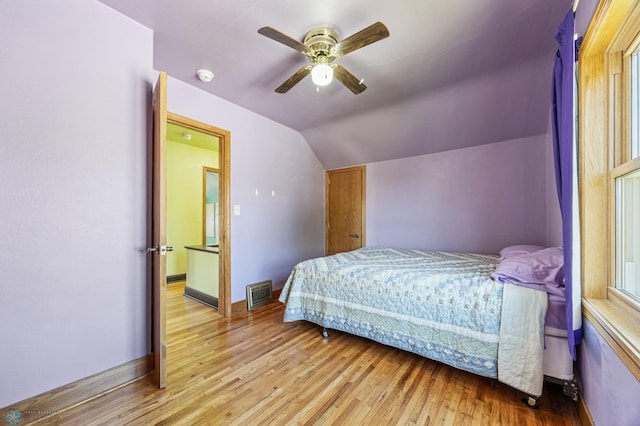 114 2nd Ave E, West Fargo, ND 58078 - bedroom featuring lofted ceiling, wood finished floors, baseboards, and ceiling fan