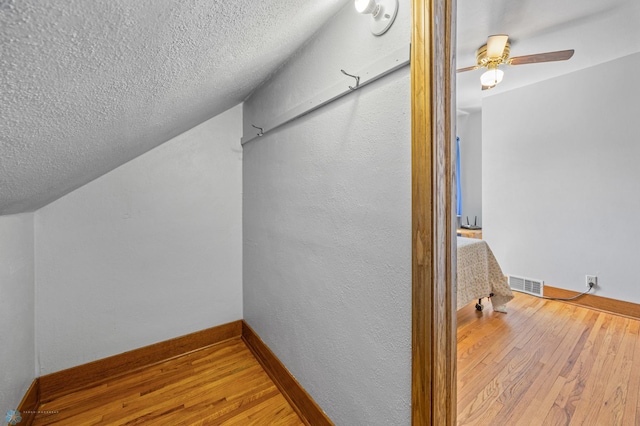 114 2nd Ave E, West Fargo, ND 58078 - spacious closet with hardwood / wood-style floors, a ceiling fan, and vaulted ceiling