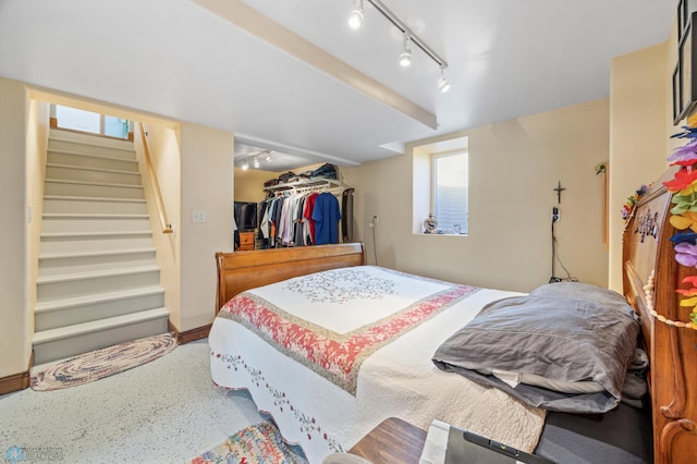 114 2nd Ave E, West Fargo, ND 58078 - bedroom featuring rail lighting, baseboards, a closet, and a spacious closet