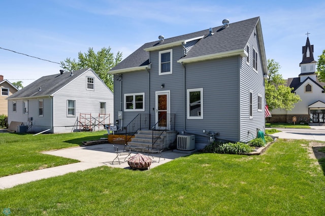 114 2nd Ave E, West Fargo, ND 58078 - back of house featuring a patio area, cooling unit, a lawn, and roof with shingles