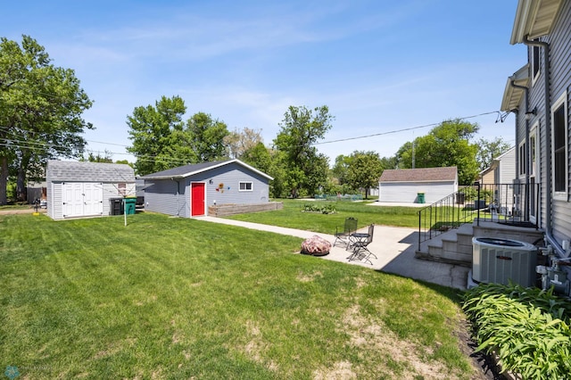 114 2nd Ave E, West Fargo, ND 58078 - view of green lawn with central AC and a patio area