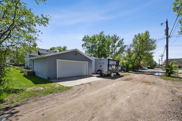 114 2nd Ave E, West Fargo, ND 58078 - view of front facade with driveway and a detached garage