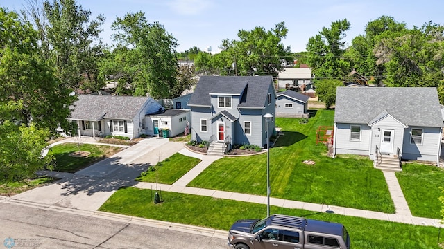 114 2nd Ave E, West Fargo, ND 58078 - view of front facade featuring driveway, a residential view, entry steps, and a front yard