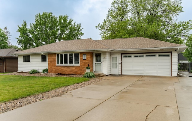 1000 17th St SW, Austin, MN 55912 - single story home featuring a garage, driveway, a front yard, brick siding, and a shingled roof