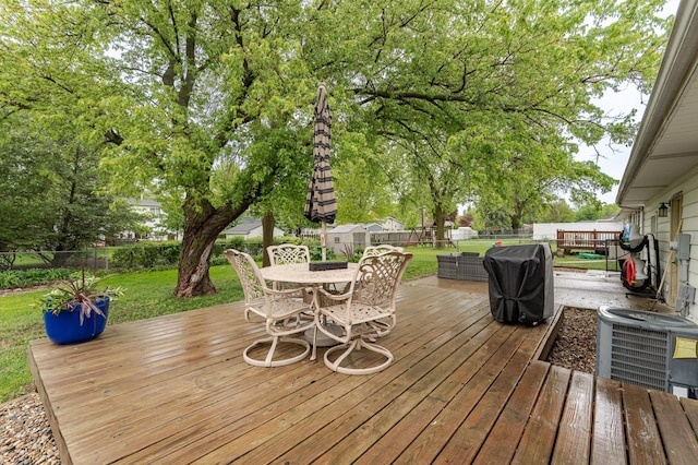 1000 17th St SW, Austin, MN 55912 - deck featuring outdoor dining area, cooling unit, and area for grilling