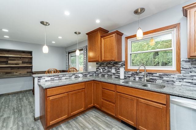 1000 17th St SW, Austin, MN 55912 - kitchen with dishwasher, a sink, brown cabinets, stone countertops, and recessed lighting