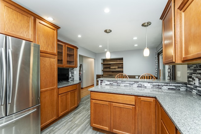 1000 17th St SW, Austin, MN 55912 - kitchen with freestanding refrigerator, brown cabinets, and recessed lighting