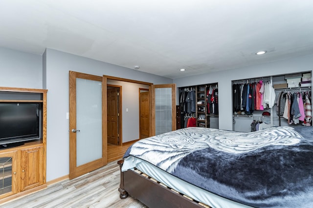 1000 17th St SW, Austin, MN 55912 - bedroom with two closets, light wood-type flooring, recessed lighting, and baseboards