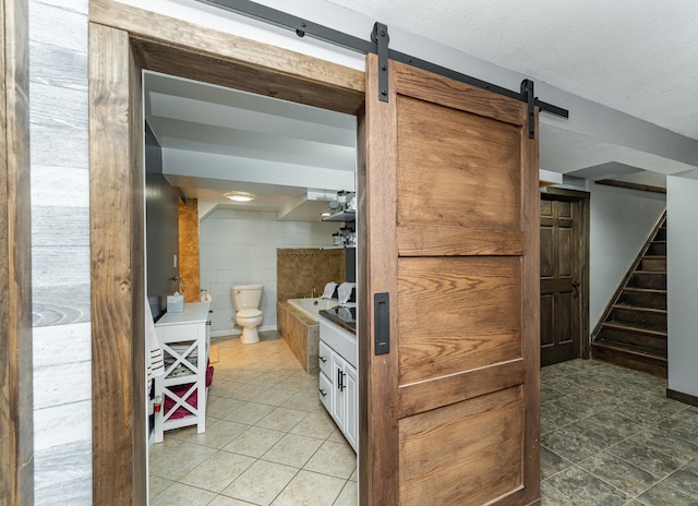 1000 17th St SW, Austin, MN 55912 - kitchen featuring a barn door and light tile patterned floors