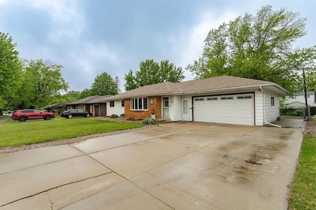 1000 17th St SW, Austin, MN 55912 - ranch-style home with an attached garage, a front lawn, concrete driveway, and brick siding